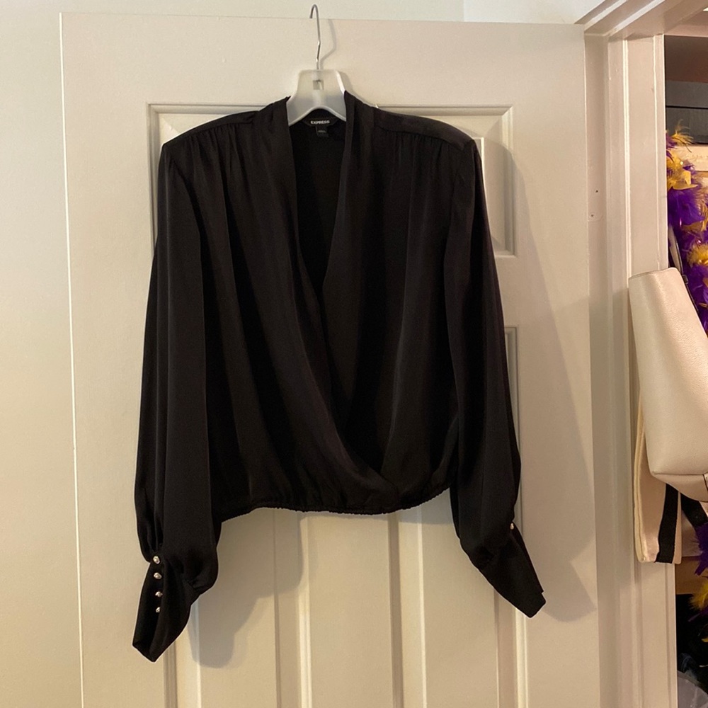 Express size small. Black blouse with jeweled cuff sleeves.